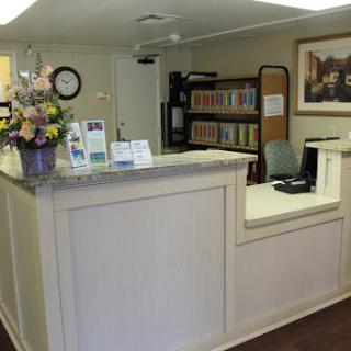 A welcoming reception area with flowers and organized files.