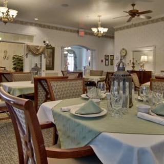 Elegant restaurant dining room with neatly set tables and classic decor.