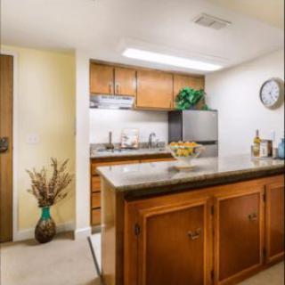 A cozy kitchen with wooden cabinets and a central island.