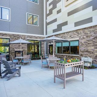 A stylish outdoor seating area featuring modern furniture and umbrellas, perfect for relaxation.