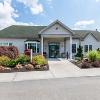 A residential building with a landscaped front yard and an inviting entrance.