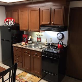 A cozy kitchen with wooden cabinets and modern appliances.