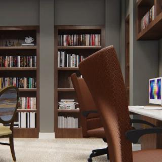 A cozy office space featuring bookshelves, desks, and comfortable chairs.