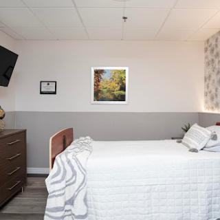 A well-designed modern bedroom featuring a comfortable bed, stylish furniture, and decorative wall art.