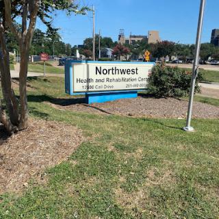 A sign for Northwest Health and Rehab Center, indicating a healthcare facility in an outdoor setting.