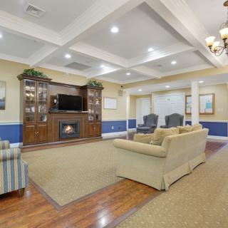A cozy living room with a fireplace, television, and comfortable seating arrangement.