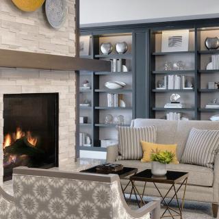 A modern living room featuring a cozy fireplace and elegantly designed bookshelves.