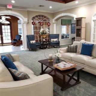 A cozy living room with comfortable sofas and a coffee table, decorated with elegant furnishings.
