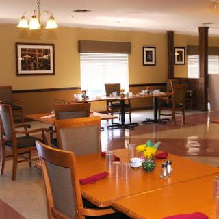 A cozy dining area with wooden tables and comfortable chairs, designed for casual meals.