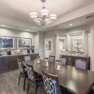 A modern conference room with a large meeting table and elegant decor.