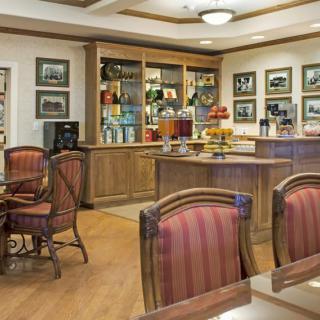 A cozy cafe interior with wooden furniture and warm lighting.