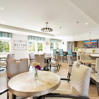A bright and modern dining area with neatly arranged tables and chairs.