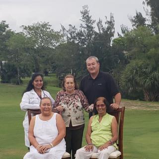 A family group photo taken on a golf course.