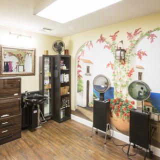 A cozy and inviting salon interior featuring a decorative mural and organized furniture.