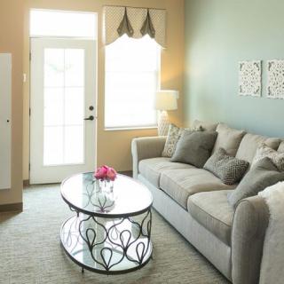 A cozy living room with a comfortable sofa, stylish coffee table, and bright natural light.