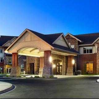 A well-lit entrance of a brick building during evening time.