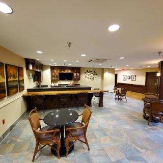 A spacious lobby featuring a bar counter and seating arrangements, designed for comfort and relaxation.