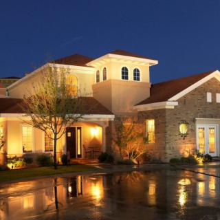 A beautifully lit house exterior at night.