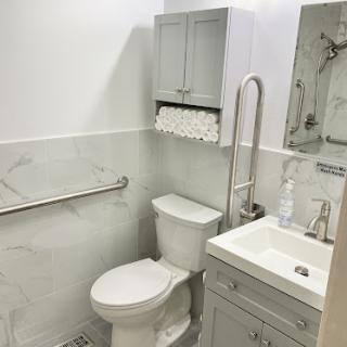 A modern and tidy bathroom featuring essential fixtures like a toilet, sink, and storage.