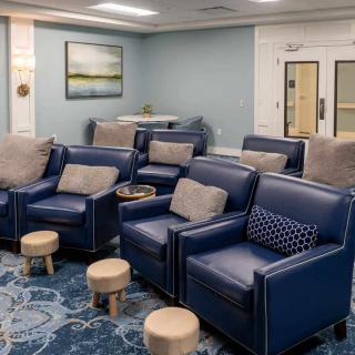 A modern lounge with blue armchairs and subtle interior decor.