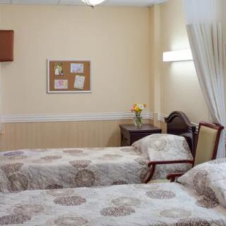 A cozy hotel room with twin beds and warm decor.