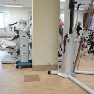 A gym with various exercise machines and workout equipment.