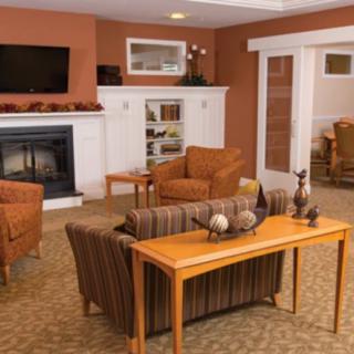 A cozy living room with comfortable seating, a fireplace, and a television.