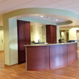 A modern reception area with wooden furniture and a well-lit ambiance.