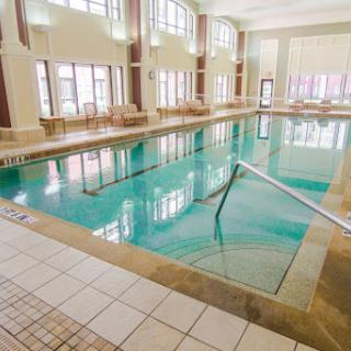 A serene indoor swimming pool bathed in natural light, perfect for relaxation and leisure.