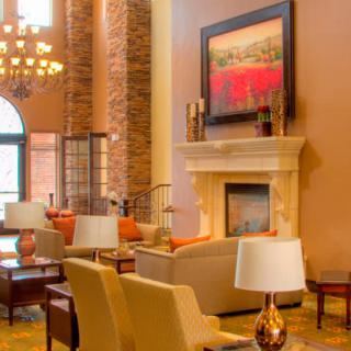 A luxurious living room interior featuring a fireplace, comfortable seating, and elegant decor.