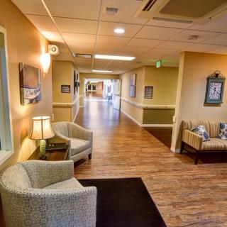 A warmly lit hallway with comfortable seating and decorative accents.
