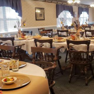 A warmly decorated dining room with neatly arranged tables set for guests.