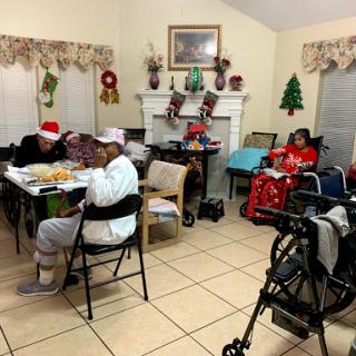 A cozy Christmas gathering featuring seniors enjoying a festive meal together.
