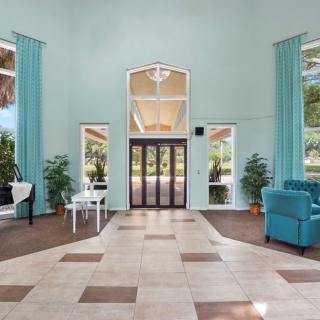 A spacious and elegantly designed lobby with modern furniture and large windows.