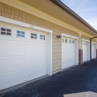 Row of closed garage doors in a residential building.