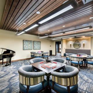 Modern lounge with a piano and comfortable seating arrangement.