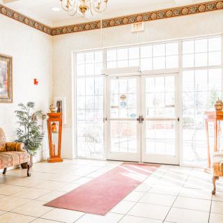 A bright and welcoming lobby with elegant furniture and natural lighting.
