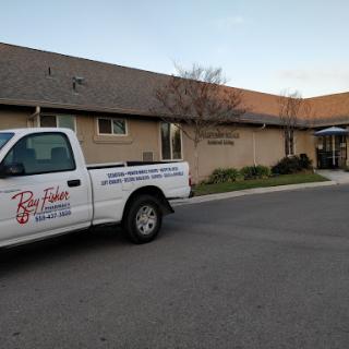 A service truck parked outside a commercial building during the evening.