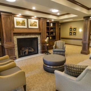 A cozy living room with a fireplace and comfortable seating arrangement.