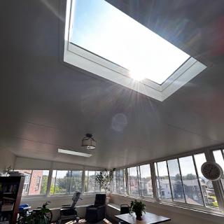 A bright and airy workspace featuring a skylight that floods the room with natural light.
