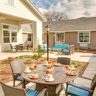 A cozy outdoor patio setup with a round table and chairs, perfect for enjoying meals on a sunny day.