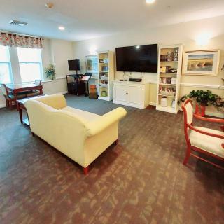 A spacious living room with comfortable seating and a large television.