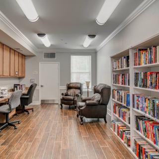 A cozy library with bookshelves and comfortable seating.