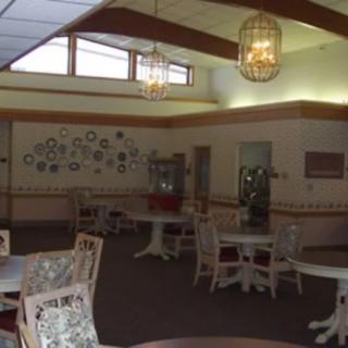 A cozy dining area with round tables and decorative wall elements.