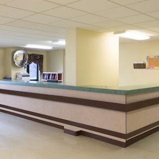 A hospital reception area with a large desk and clean, bright surroundings.
