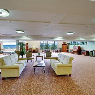 A spacious lobby with comfortable seating arrangements and large windows.