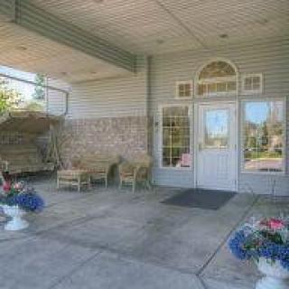 A welcoming entrance with outdoor seating and decorative plants.