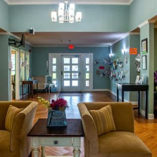 A welcoming lobby area featuring comfortable seating, decorative lighting, and vibrant wall art.