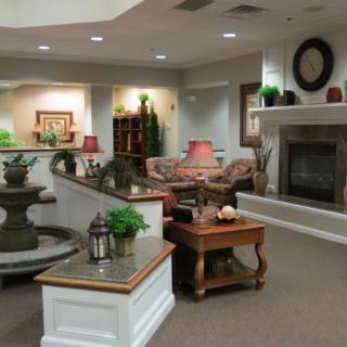 A cozy living room with comfortable furniture and a warm fireplace.