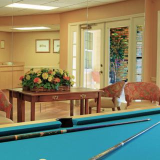 A cozy recreation room with a pool table and seating area.